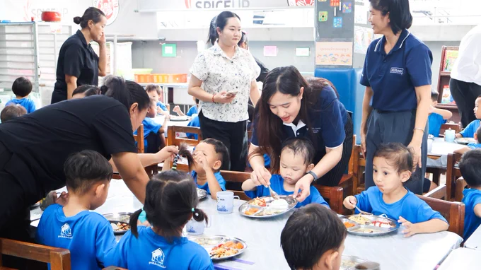 รูปที่ 4: ทีมงานจาก Millennium Hilton Bangkok กำลังป้อนอาหารมาให้เด็กที่อยู่ข้างหน้า

Picture 4: Team member from Millennium Hilton Bangkok is feeding foods for a child in the front.