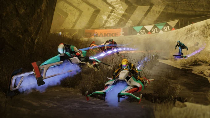 Four sparrrow riders speeding through a rocky Venus track. Two racers lead in the foreground, leaving glowing blue energy trails, while others follow behind.