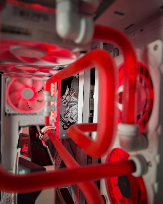 A close up of SHUGO DDR5 RAM as shown in the Onyx Blade style.  It is threaded through several AIO guided tubes in a rich, deep red color. 