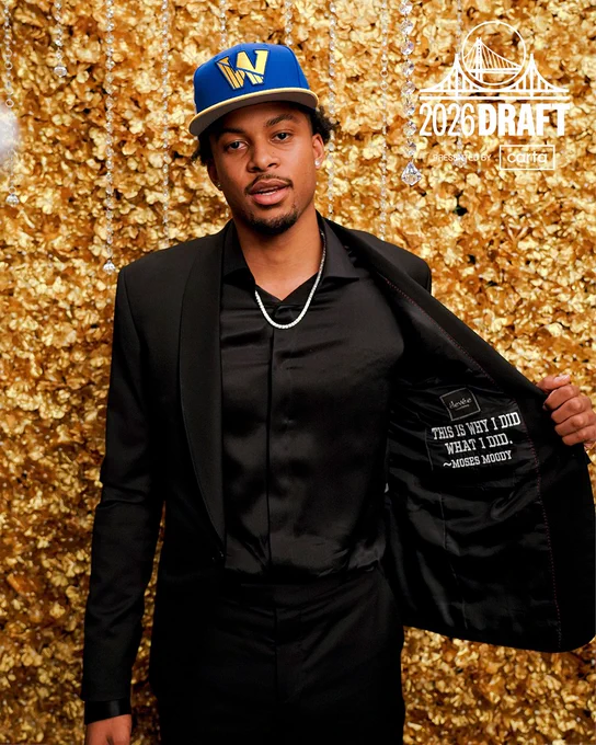 Moses Moody showing the inside of his suit jacket at a photoshoot on NBA Draft night in 2021.
