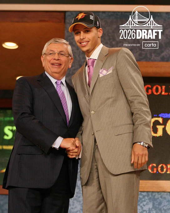 Stephen Curry shaking former NBA Commissioner David Stern's hand on stage after being selected by the Warriors in the 2009 Draft.