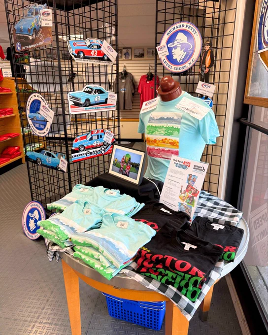 A table set up with Victory Junction merchandise in the Petty Museum.