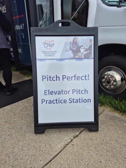 A sign in front of the OOD mobile services unit reads, "Pitch Perfect! Elevator Pitch Practice Station." OOD logo.