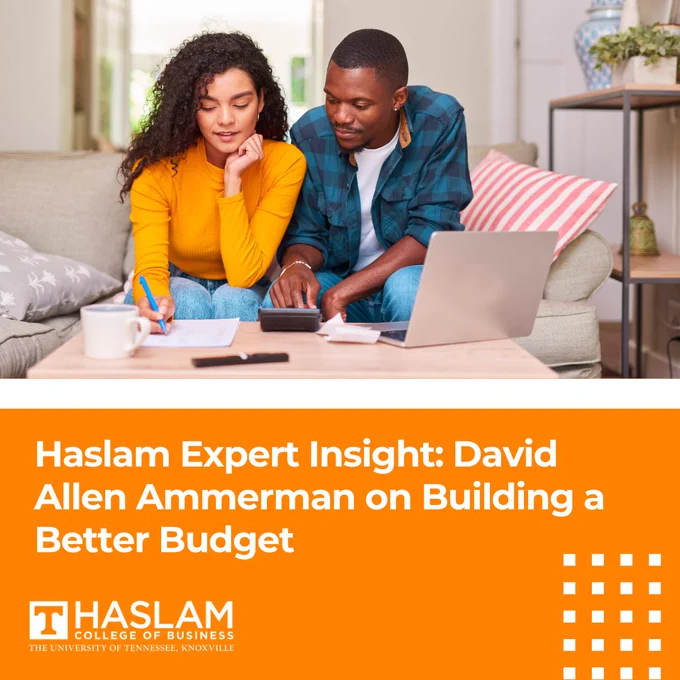 A person in a yellow sweater and another in a teal shirt are sitting on a couch, focused on a calculator and laptop. A text overlay reads, "Haslam Expert Insight: David Allen Ammerman on Building a Better Budget." The Haslam College of Business logo is at the bottom.