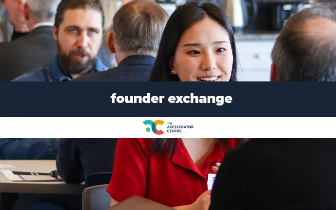 A person in a red shirt is seated at a table engaged in conversation with others with several people sitting at tables in the background and text overlay that  reads "founder exchange" with The Accelerator Centre logo.