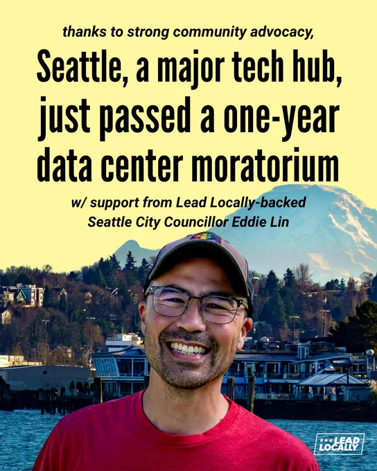 A man in a red shirt is smiling in front of mountains