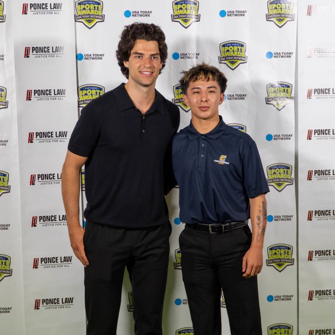 Photo of Luke Evangelista posing with a fan at the Middle Tennessee High School Sports Awards
