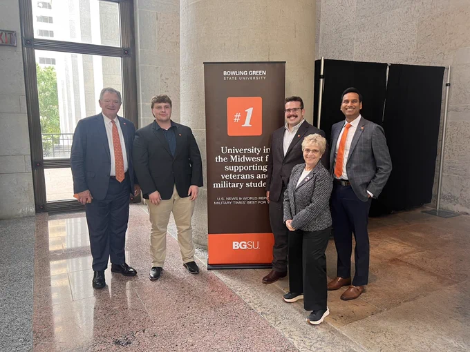 Group of people standing in front of a BGSU sign