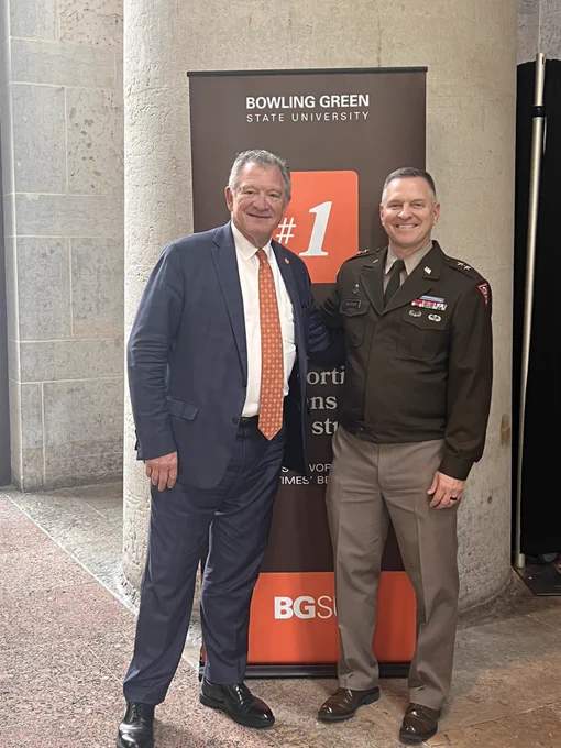Two people standing in front of BGSU sign