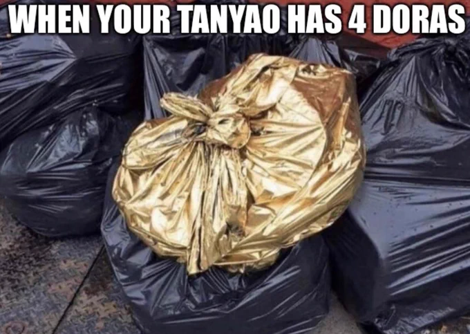 A trash bag made of gold with text across the top that reads "when your tanyao has 3 dora" 