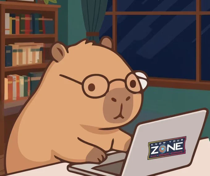 Graphic of a capybara with glasses on a computer in a home office. The computer has a sticker that says “Know Your Zone. Plan. Prepare. Evacuate” on it.