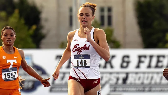 A runner wearing a uniform with "Eagles" on it competes on a blue track, flanked by other athletes. One athlete wears an orange outfit with "Tennessee" printed on it. A "Track & Field" banner is visible in the background.