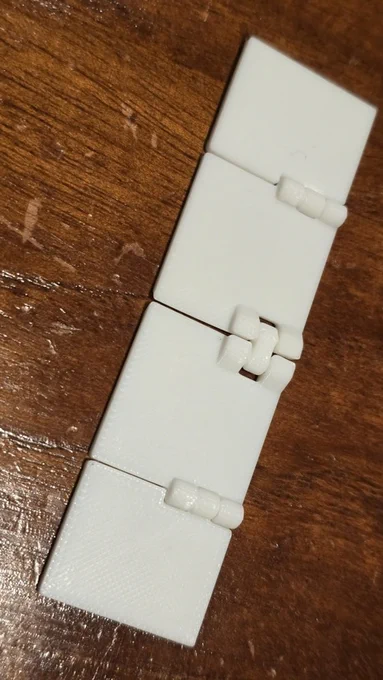 Folded flat, with rows of hinges like this, there is very little play, making it suitable for a marking template that folds down compactly.