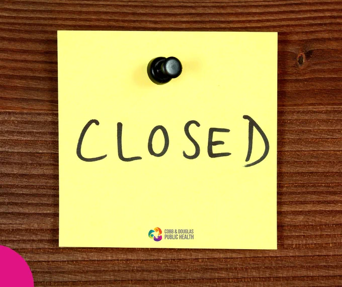 Yellow sticky note pinned to wood with the word CLOSED written in black marker.