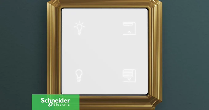Ein Schalter von Schneider Electric mit goldenem Rahmen an einer dunkelgr\u00FCnen Wand, mit Symbolen f\u00FCr Beleuchtung und Jalousien.
