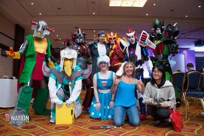 A group of TFNationals posing for a group photo together, most of them in cosplay.