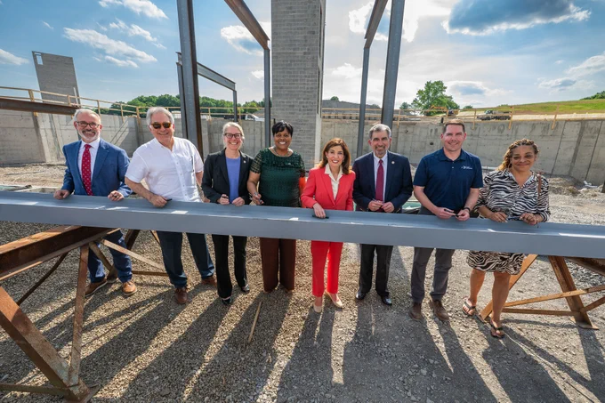 Governor Hochul joins local, state, and corporate dignitaries to sign a steel beam that is being used in the $130M syracuse construction project.