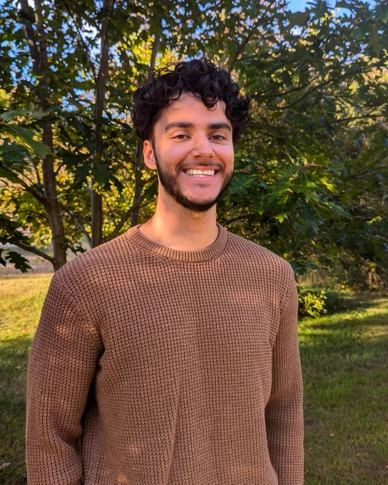 Ethan Cowan-Kazmi smiles at the camera.