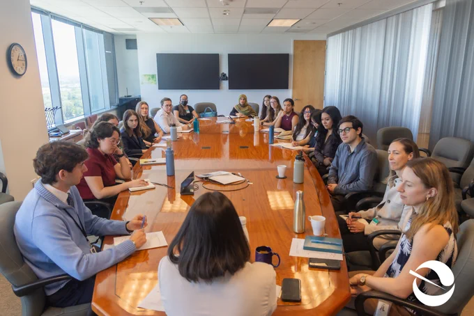 Executive Fellows and Secretary Yana Garcia sitting at a large table