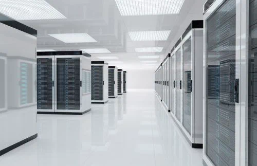 A spacious, well-lit data center with rows of sleek, metallic server racks on a shiny white floor, conveying a sense of technology and efficiency.