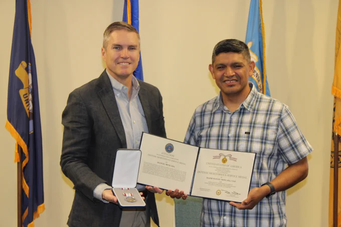 AFHSD Division Chief U.S. Navy Capt. Richard Langton awarded U.S. Air Force Maj. Manuel Moncada. Moncada helped to drive annual laboratory capability surveys that provided an inventory of global biosurveillance assets, enabling strategic planning across the enterprise. As the leader for the Pathogen Detection Project 2.0, Moncada benchmarked the capabilities of Department of War laboratories against novel biological threats.