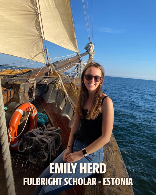 Photo of Emily Herd in a boat on the water. Text on photo: Emily Herd. Fulbright Scholar. Estonia. 