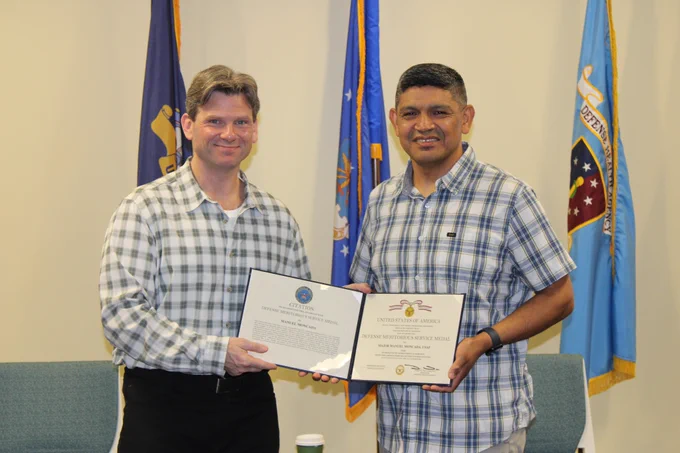 U.S. Air Force Maj. Manuel Moncada received the award from GEIS Branch Chief Lt. Col. Brett Swierczewski. Moncada provided oversight of a multi-million dollar respiratory infections surveillance portfolio that informed the Food and Drug Administration’s annual influenza vaccine selection.