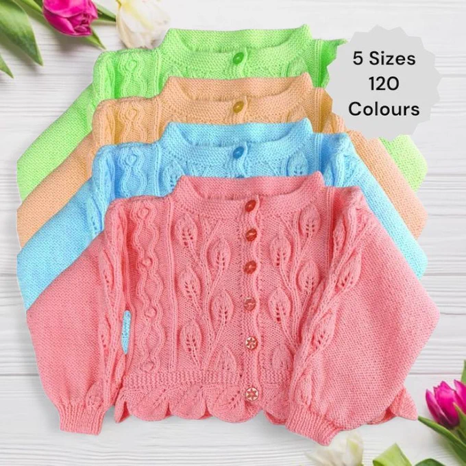 Four knitted baby cardigans are fanned out on a white wooden surface. Front one is pink with an intricate leaf design pattern and pink buttons. Behind it: light blue, yellow, and green. All have matching leaf patterns. Top right label reads "5 Sizes 120 Colours". Pink and white tulips frame the corners, adding a fresh touch.