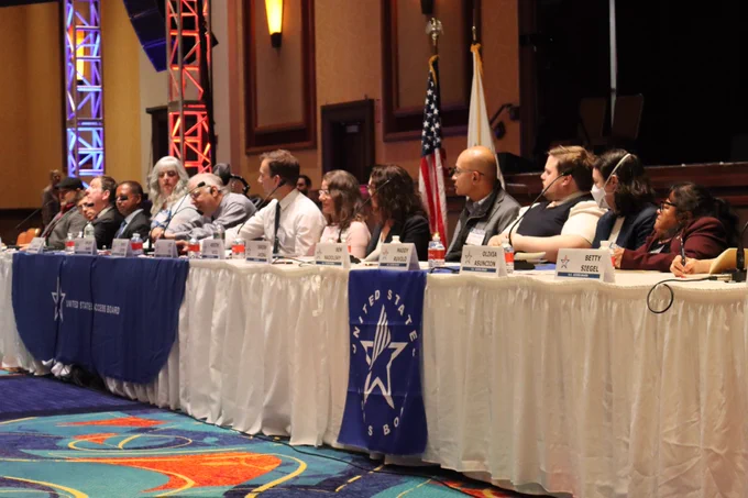 The head table at the town hall with around a dozen Board Members.