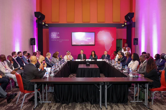 A panel discussion at the Africa CEO Forum with attendees in a conference room. The atmosphere is formal and professional, highlighting discussions on Africa's economic future.