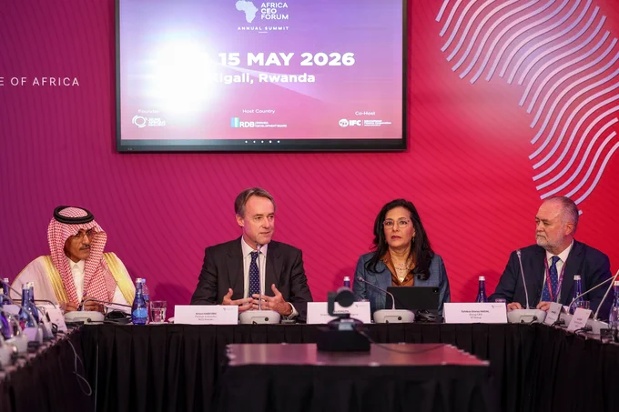 Business leaders engage in a panel discussion during the Africa CEO Forum in Kigali, Rwanda. A sense of collaboration fills the room.