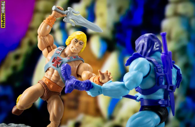 he-man fighting skeletor with his sword