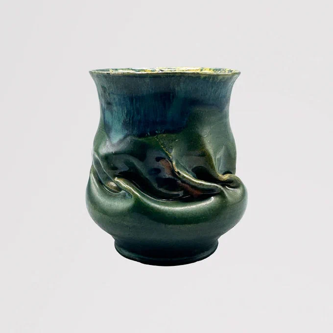 From the Ohr-O'Keefe Museum of Art George E. Ohr Collection. Image of green and blue Vase,  with wave-like swirls in the pottery design, Undated. 