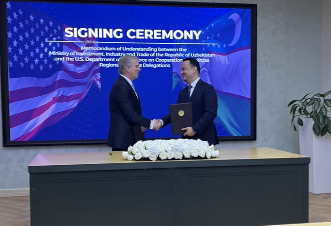 Photo featuring Assistant Secretary Fogel during a signing ceremony.