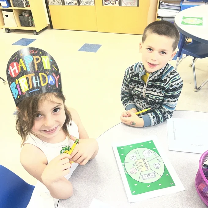 KRO plays money spin to practice learning coins and the $1 bill.