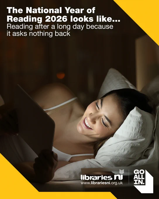 Woman smiling while reading on a tablet in bed at night. Promotes National Year of Reading 2026.