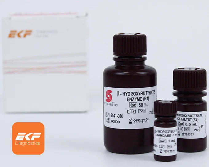 Three labeled reagent bottles for β-Hydroxybutyrate enzyme testing with varying volumes, placed in front of a blurred EKF Diagnostics box.