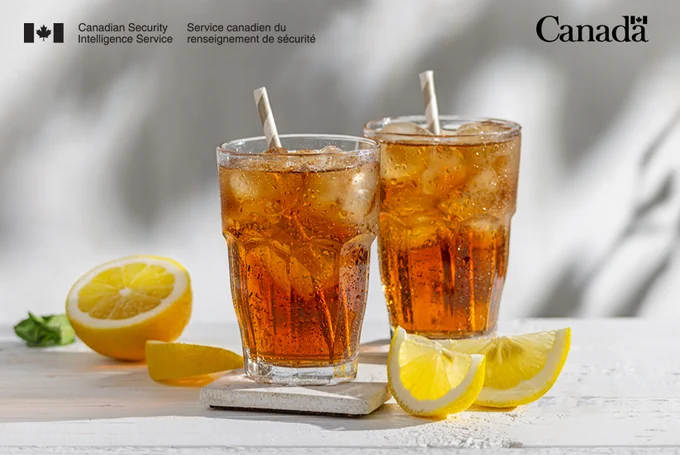 Two glasses of iced tea with lemon slices on the side.