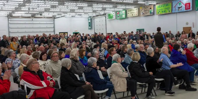 A photo of Rob Sand speaking to a packed room during his 2025 Town Hall Tour stop in Decorah.