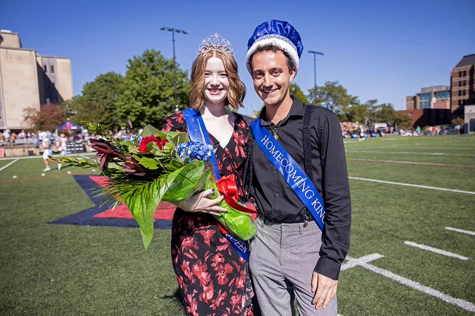 Sklyer and Braden Niles, right, pose for a photo having just been crowned Homecoming Queen and King on Rooney Field during Homecoming. Skyler is also holding a large bouquet of flowers.