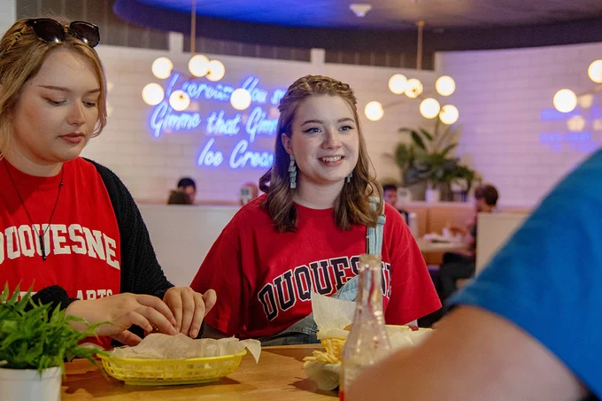 Skyler, center, has lunch with friends at Moonlit Burgers.