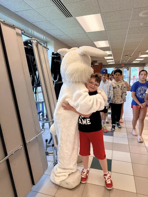 bunny mascot hugs student