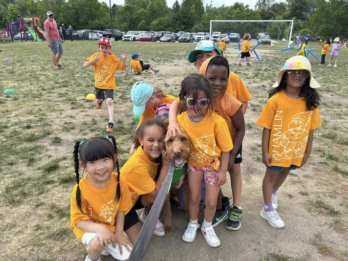 Students with dog at field day