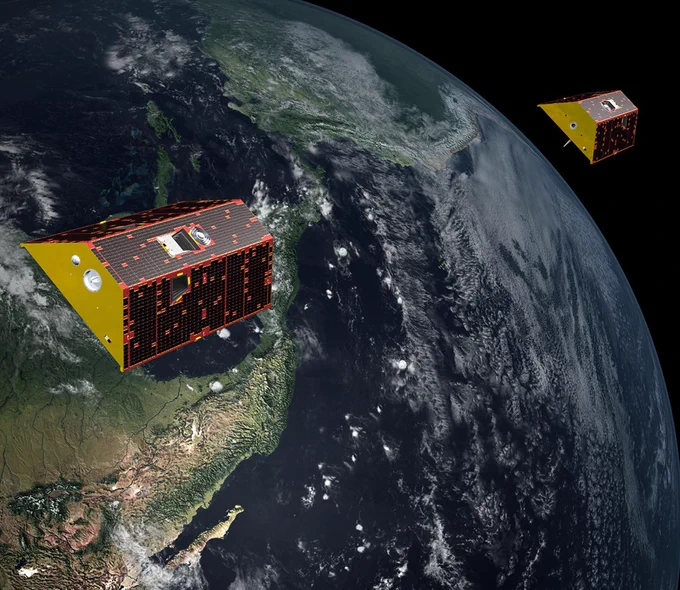 Artist’s illustration of the twin spacecraft of the GRACE-FO mission. The two satellites look similar and look like they are following each other as they orbit Earth. Below the satellites, parts of Central and South America are visible as green land masses surrounded by dark blue water. Credit: NASA/JPL-Caltech 