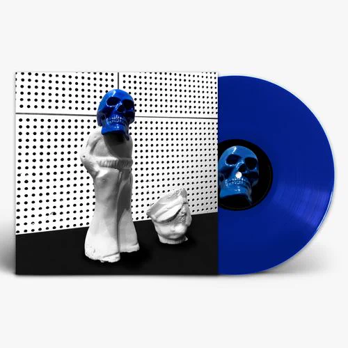 A striking blue vinyl record stands out against a monochrome background featuring a sculpted figurine with a blue skull face. The setting has an artistic and enigmatic mood.