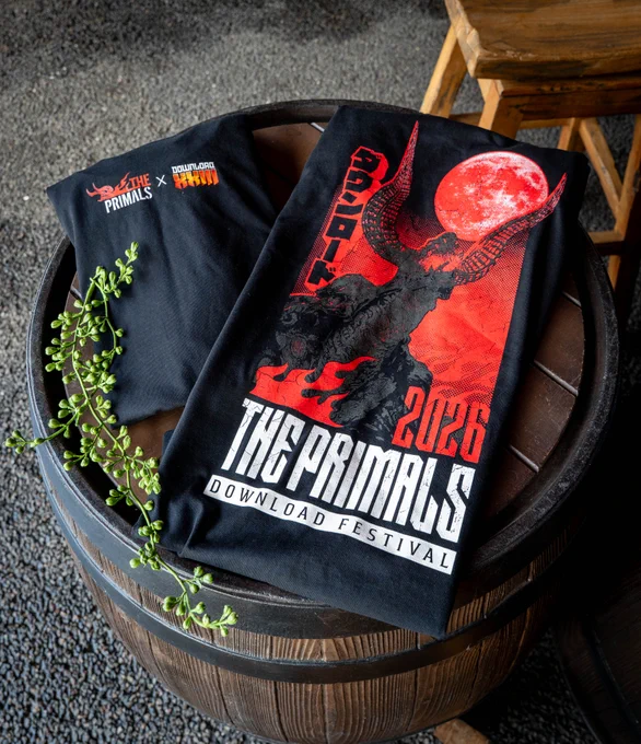 A photograph showcasing two The Primals at Download Festival 2026 T-shirts. Design on the front shows a red print of Ifrit roaring under the full moon. The back of the T-shirt shows both logos of The Primals and Download Festival. 