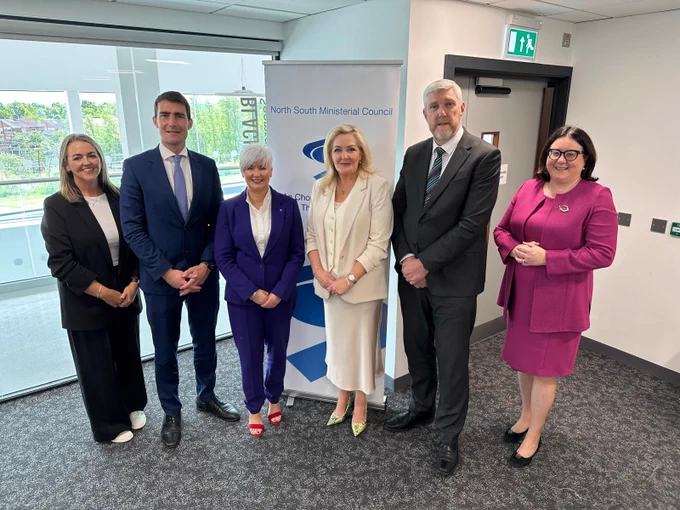 Minister O'Dowd stands with Ministers and SEUPB representatives who attended the meeting.