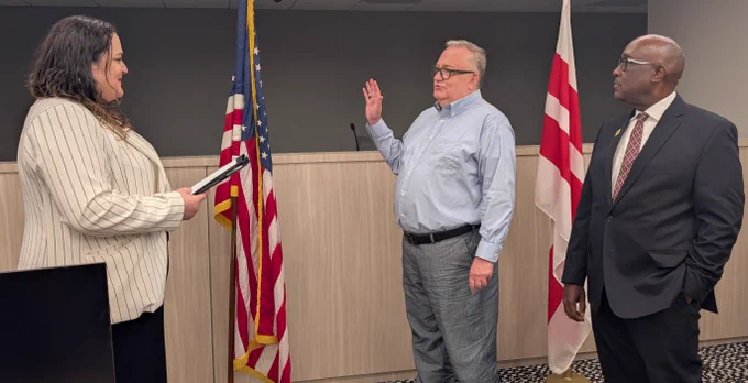 James Turner is sworn in by Vida Rangel, Deputy Director, Mayor's Office of Talent and Appointments, along with ABC Board Chair Donovan Anderson