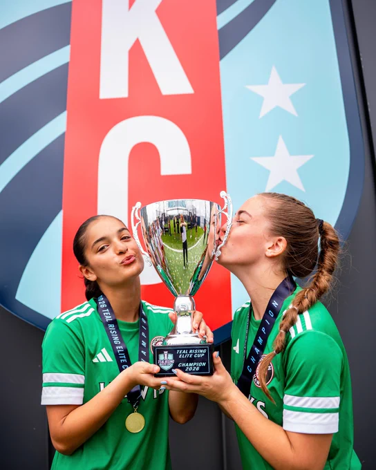 Teal Rising Elite Cup participants holding the trophy and celebrating after winning