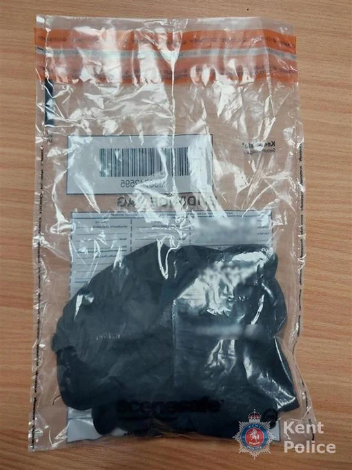 A sealed evidence bag containing black gloves, with Kent Police branding.